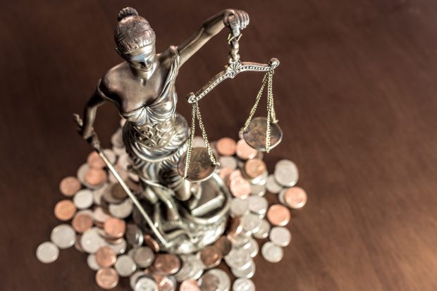 Statue of Justice standing on coins